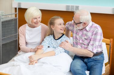 Grandparents with child in hospital  clipart