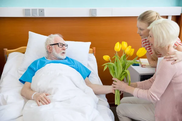 Großmutter und Enkelin besuchen Patientin — Stockfoto