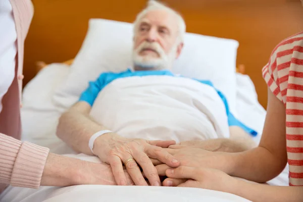 Grandmother and grandfather holding hands with patient — Stock Photo, Image