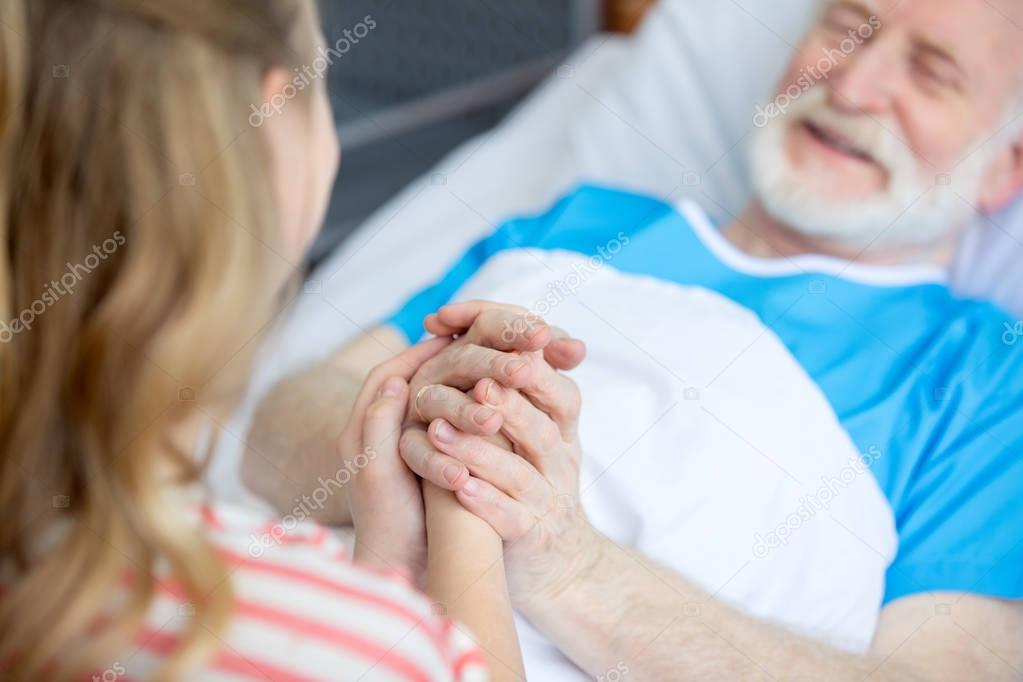 grandfather and child holding hands