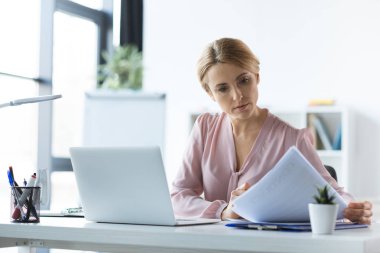 serious businesswoman working with documents clipart