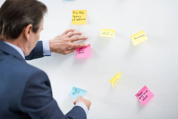 Businessman putting sticker on board — Stock Photo, Image