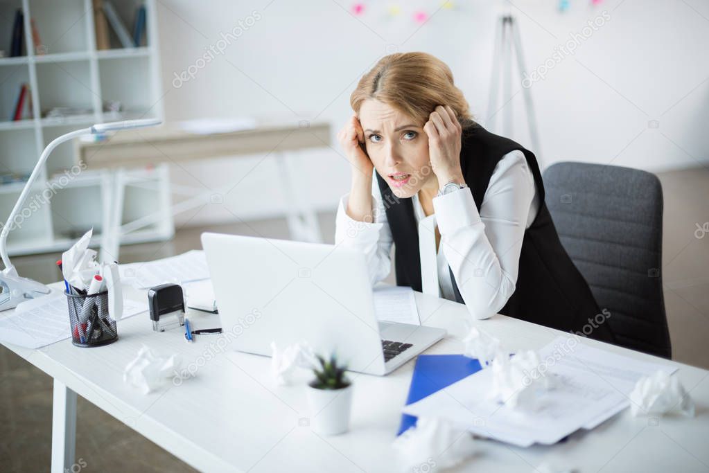 Stressed businesswoman at workplace 