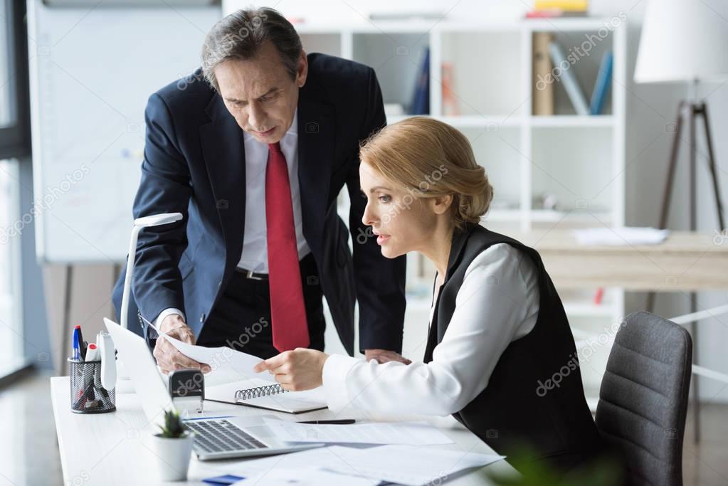 Businesspeople discussing documents 