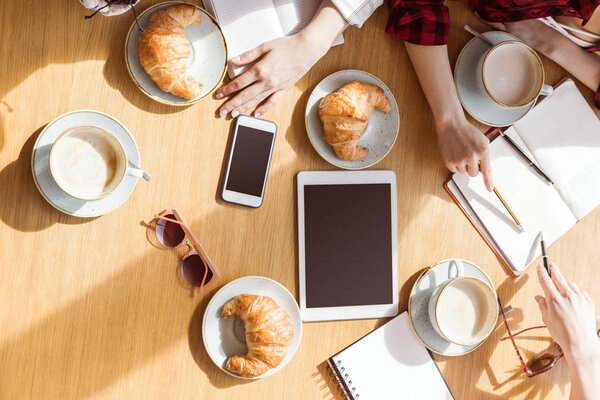 women sitting with digital devices