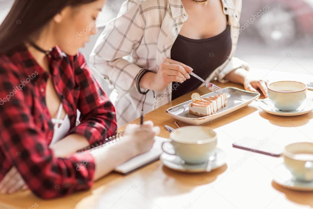 girls eating cake and drinking coffee