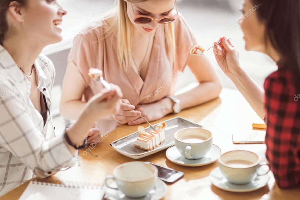 girls eating cake and drinking coffee