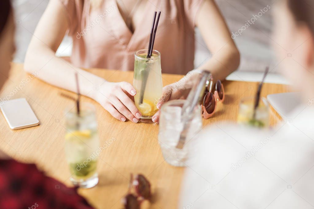girls drinking cocktails in cafe