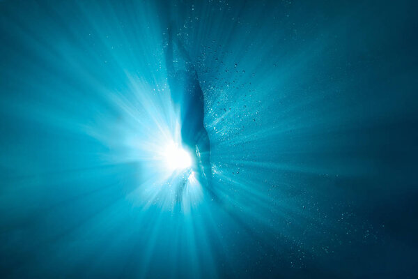 underwater picture of professional swimmer exercising in swimming pool