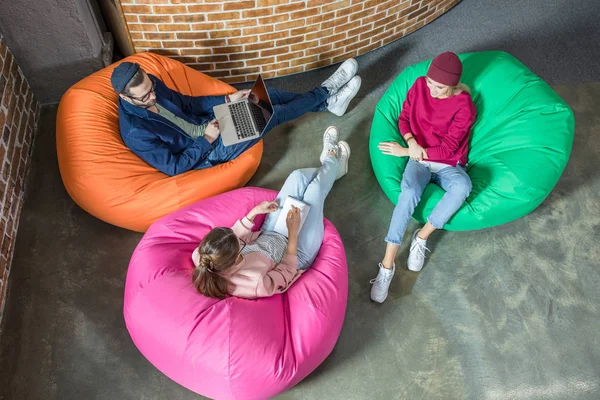 People in bean bag chairs — Stock Photo