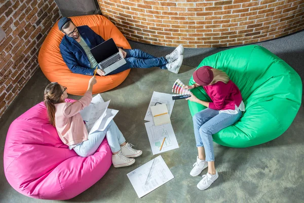 People in bean bag chairs — Stock Photo