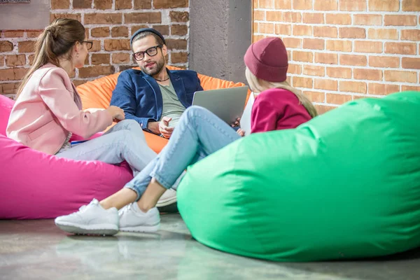 People in bean bag chairs — Stock Photo