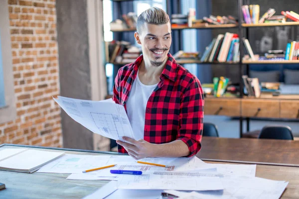 Male architect with blueprints — Stock Photo