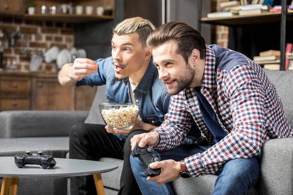 Men playing with joysticks — Stock Photo