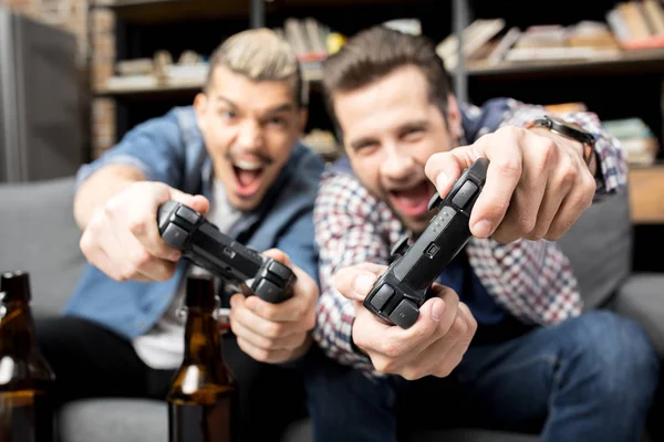 Men playing with joysticks — Stock Photo