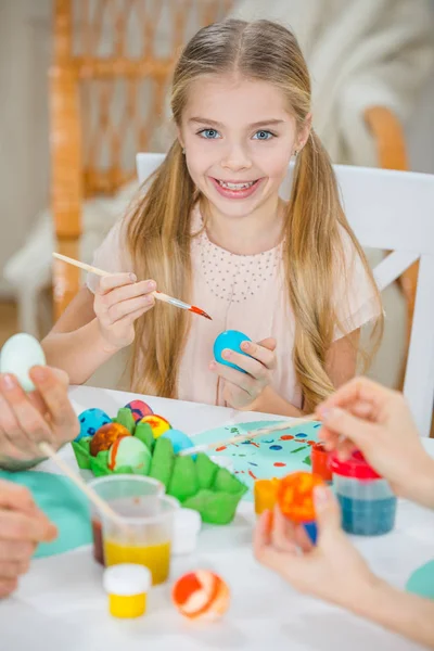 Girl painting Easter eggs — Stock Photo