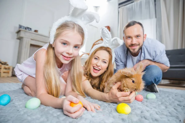 Family playing with rabbit — Stock Photo