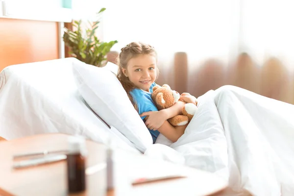 Little girl in hospital bed — Stock Photo