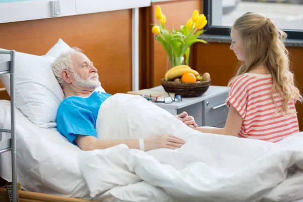Senior patient with granddaughter — Stock Photo