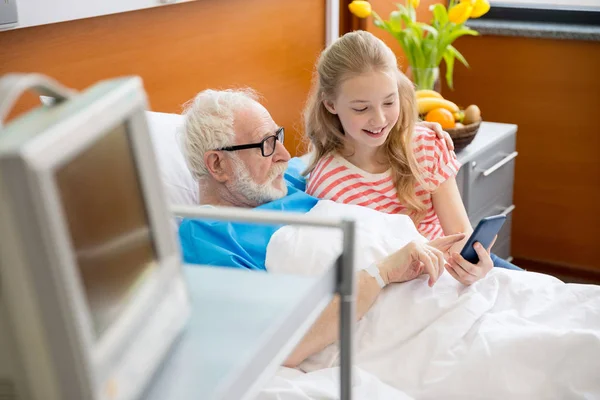 Grandfather and child using smartphone — Stock Photo
