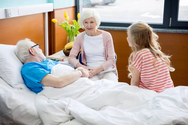 Grandmother and granddaughter visiting patient — Stock Photo