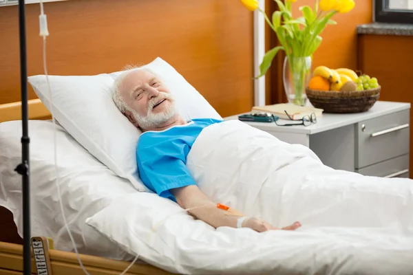 Senior man in hospital bed — Stock Photo