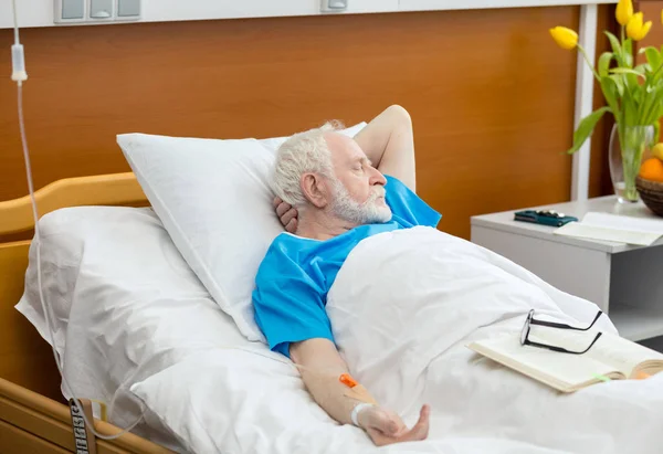 Senior man in hospital bed — Stock Photo