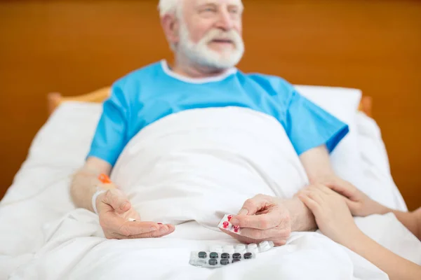 Senior man with pills — Stock Photo