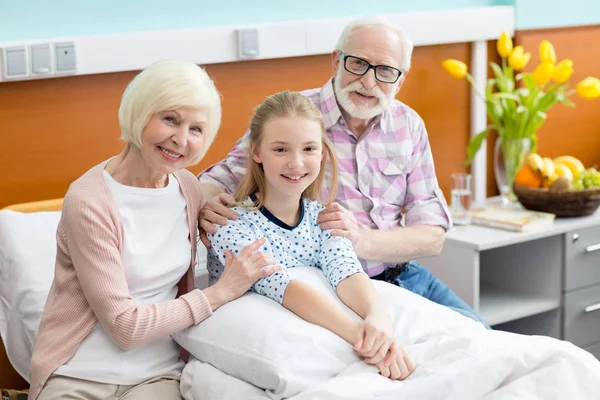 Grandparents with child in hospital — Stock Photo