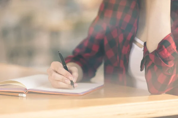 Asian student studying in cafe — Stock Photo