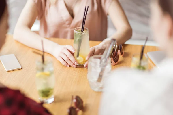 Girls drinking cocktails in cafe — Stock Photo