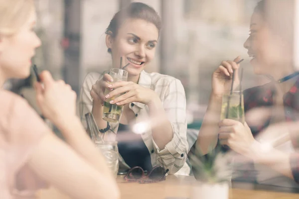 Girls drinking cocktails in cafe — Stock Photo