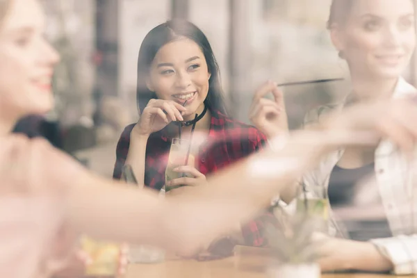 Girls drinking cocktails in cafe — Stock Photo