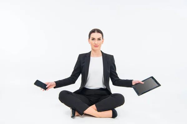 Businesswoman sitting with devices — Stock Photo, Image
