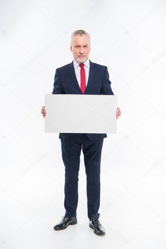 Businessman holding blank card