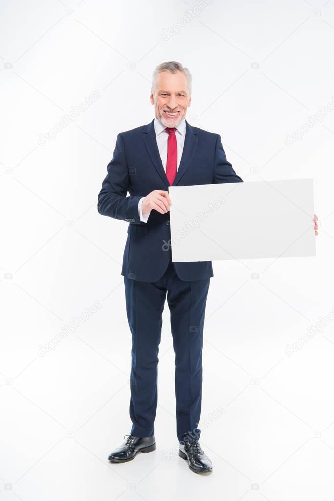 Businessman holding blank card 