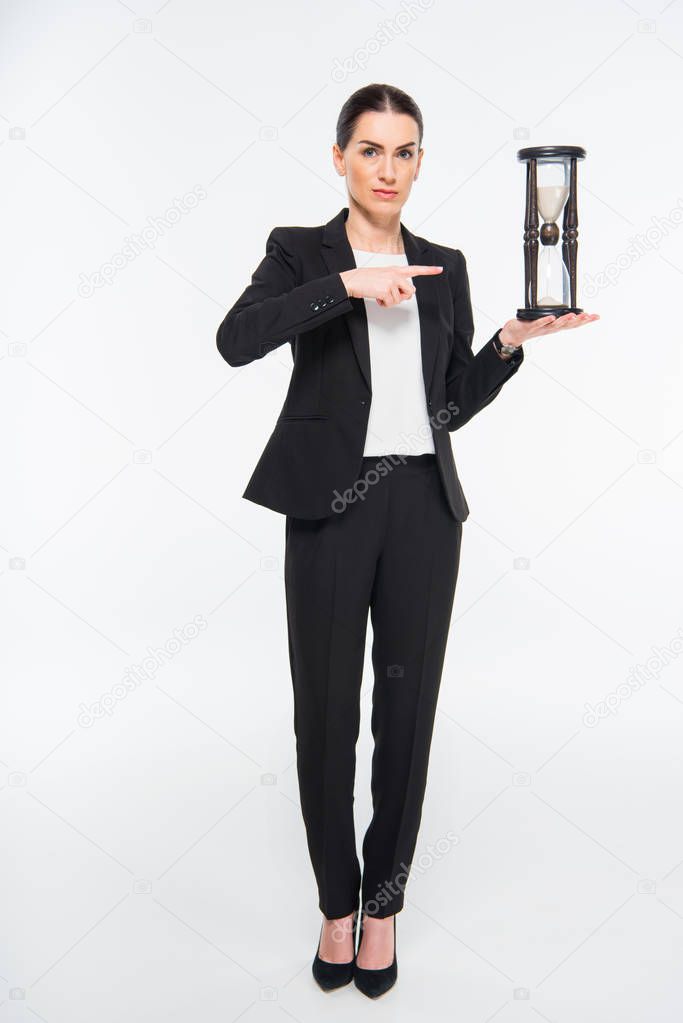 Businesswoman holding hourglass