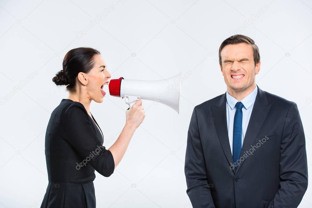 Businesswoman screaming at businessman