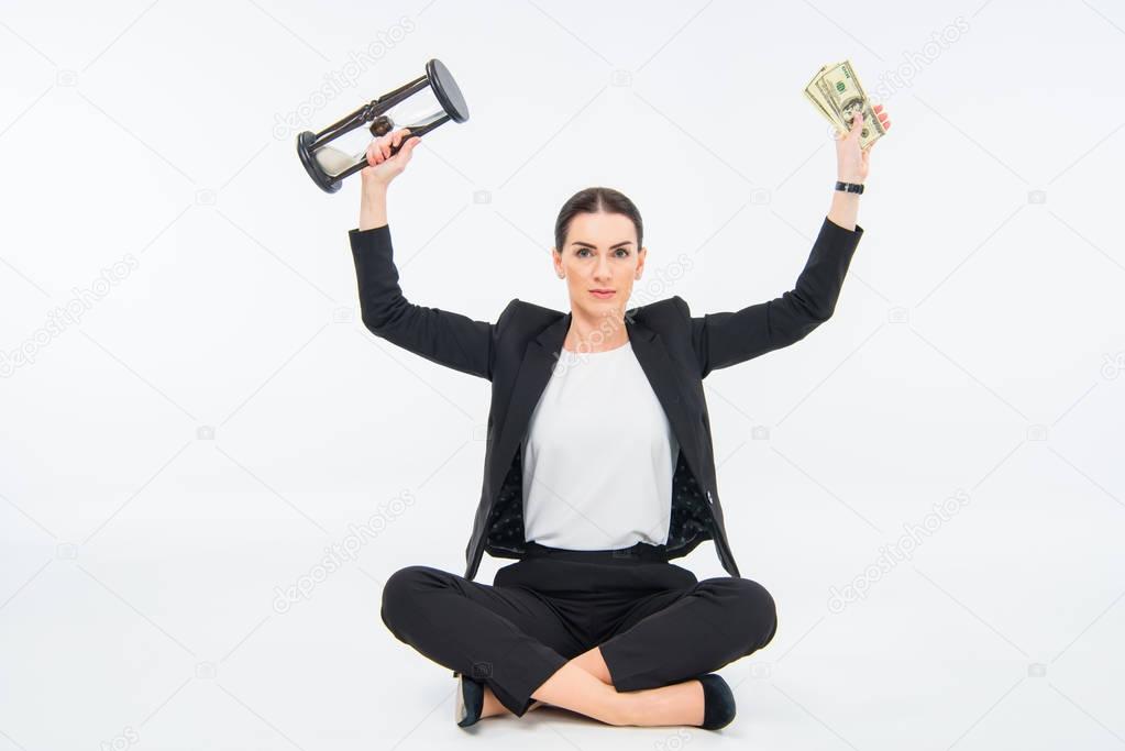 Businesswoman with hourglass and money