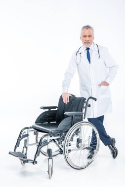 Smiling doctor with wheelchair  clipart