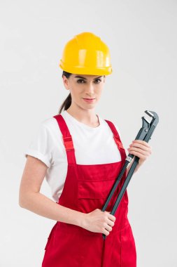 Female builder holding wrench clipart