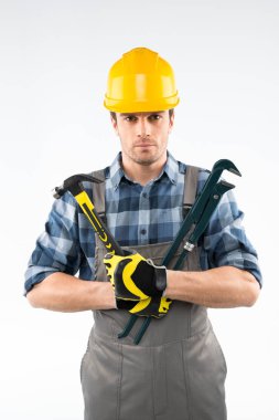 Workman holding hammer and pipe wrench  clipart