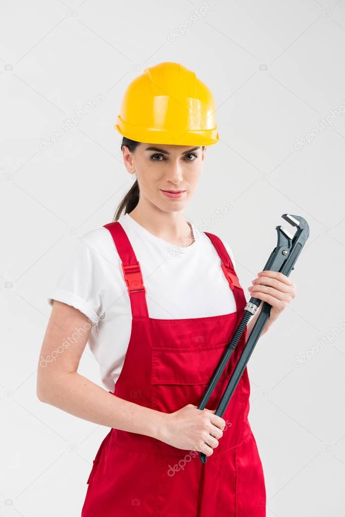 Female builder holding wrench