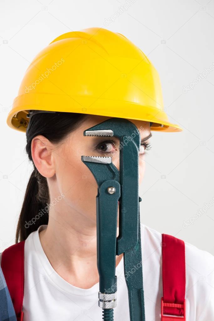 Female builder holding wrench