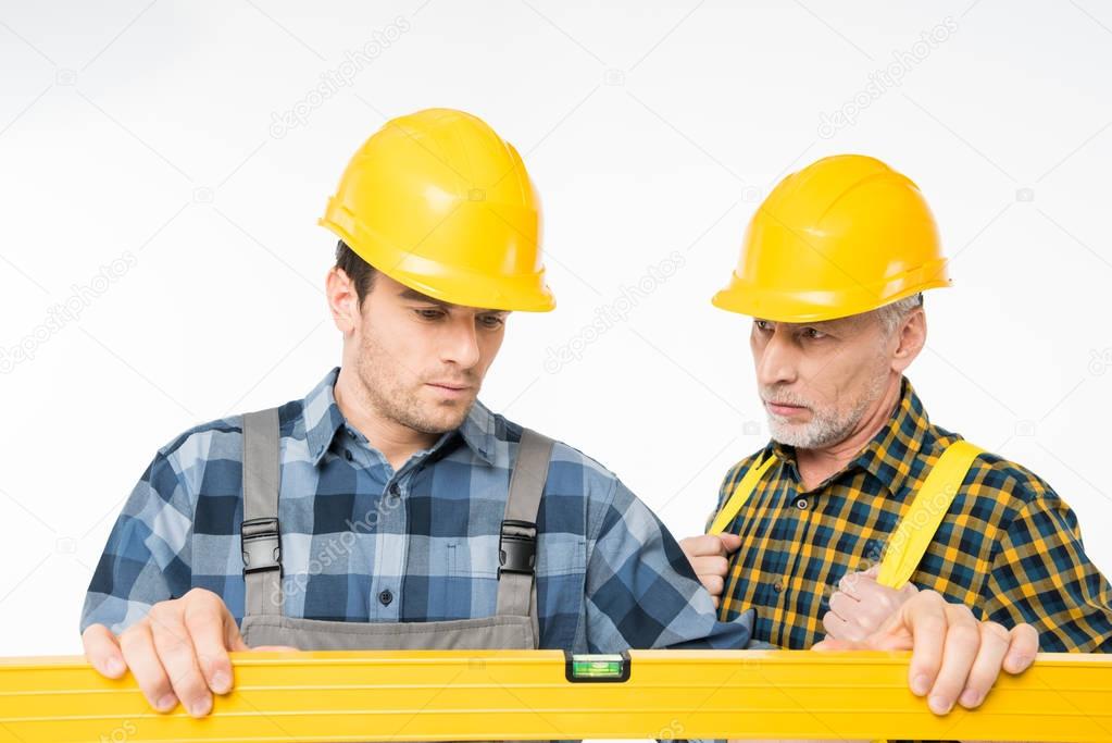 Workmen with level tool