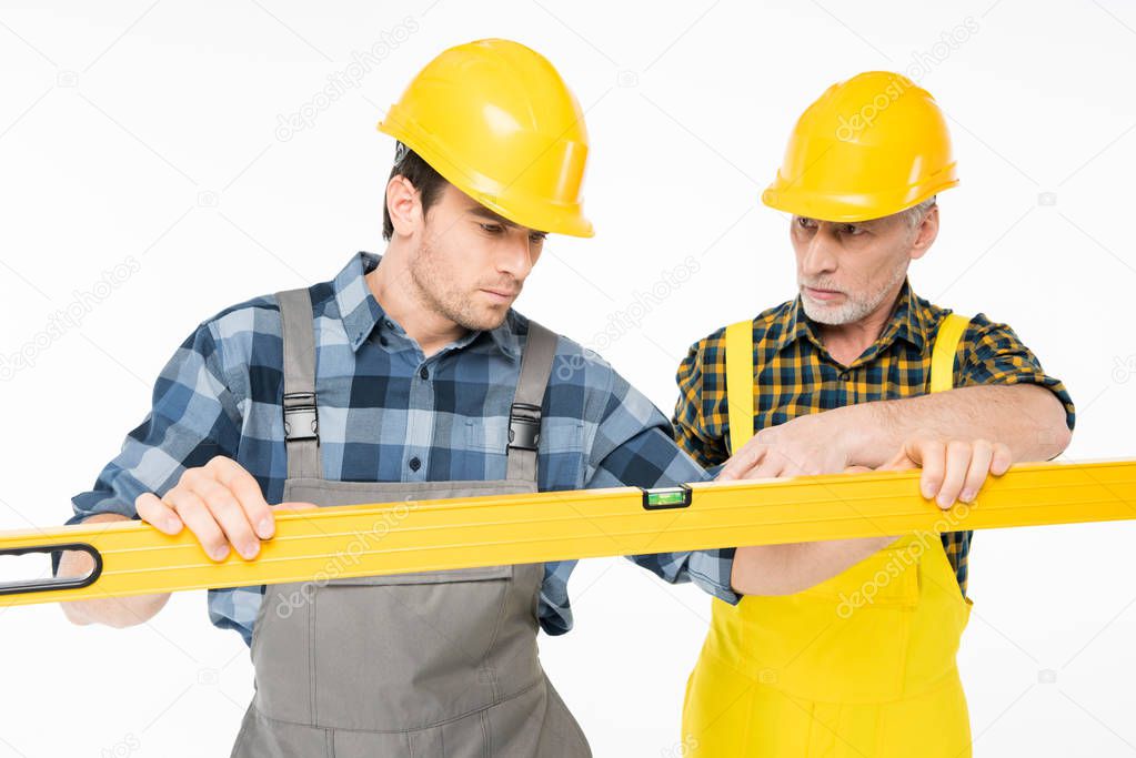 Workmen with level tool