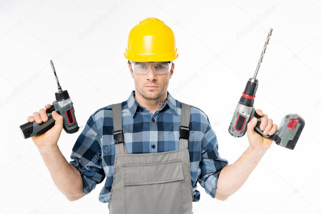 Workman holding electric drills