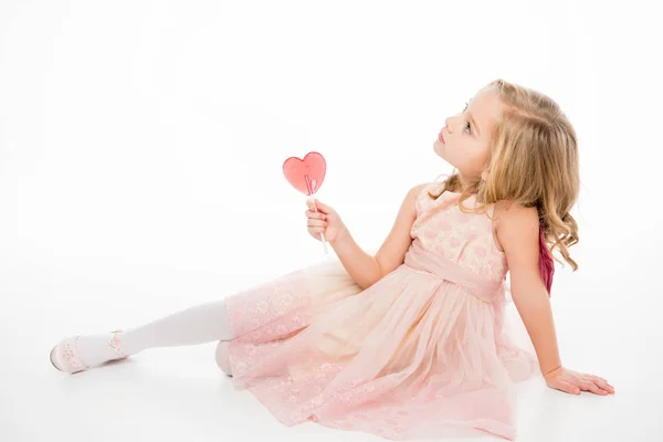 Girl with heart shaped lollipop — Stock Photo, Image