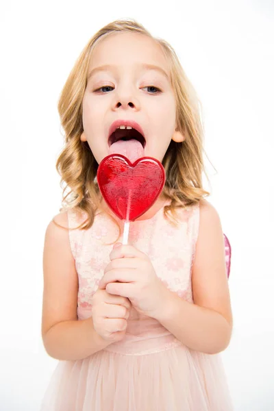 Lány szív alakú nyalókával — Stock Fotó