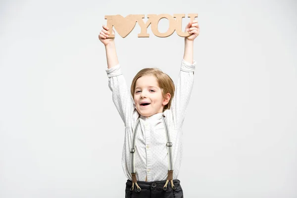 Niño sosteniendo palabras de madera — Foto de Stock